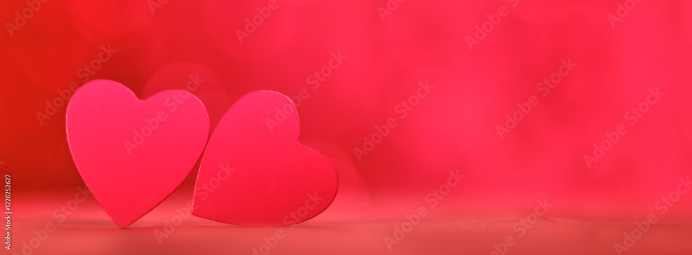 Two red heart shapes positioned against a vivid abstract red background, representing love, romance, and passion in an expressive and modern style. Two red heart shapes positioned against a vivid abstract red background, representing love, romance, and passion in an expressive and modern style.