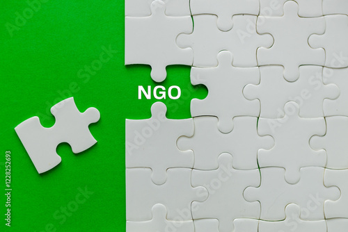 Obraz na płótnie NGO Symbol. Taken out of the puzzle revealing the NGO Abbreviation.Concept of NGO Non-Governmental Organization and Charity. Donation, Foundation, Nongovernmental non profit organization, copy space w salonie