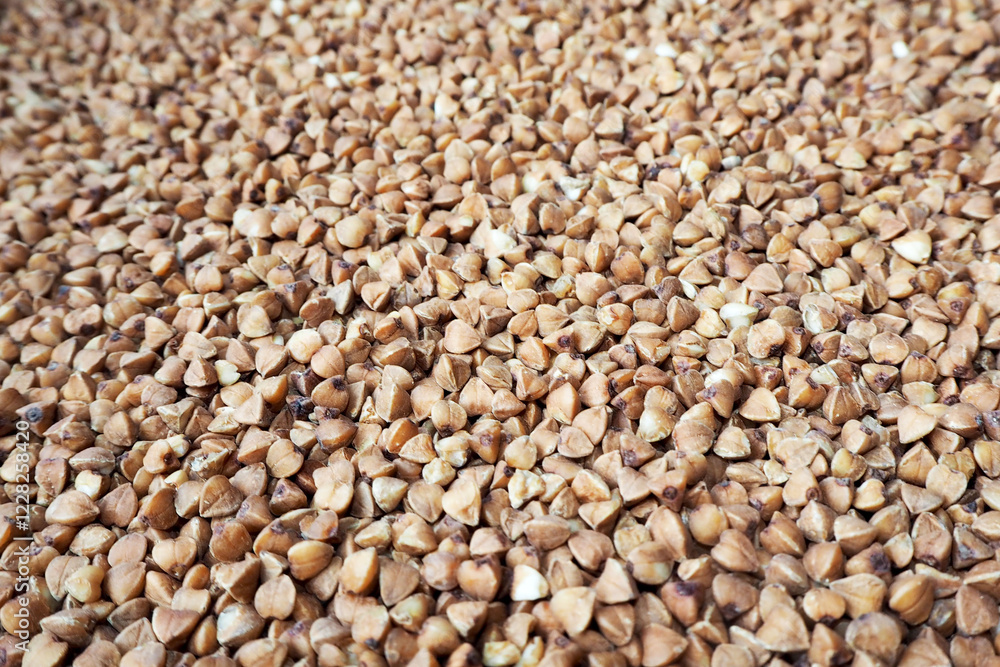 Fototapeta premium raw buckwheat groats . brown background