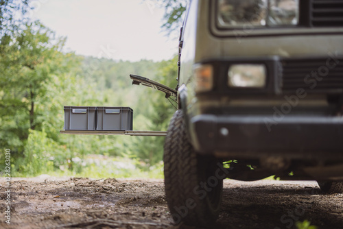 Obraz na płótnie Two plastic euro box on a pull out drawer of a vintage adventure offroad vehicle or motor home, parked outside in a forest w salonie