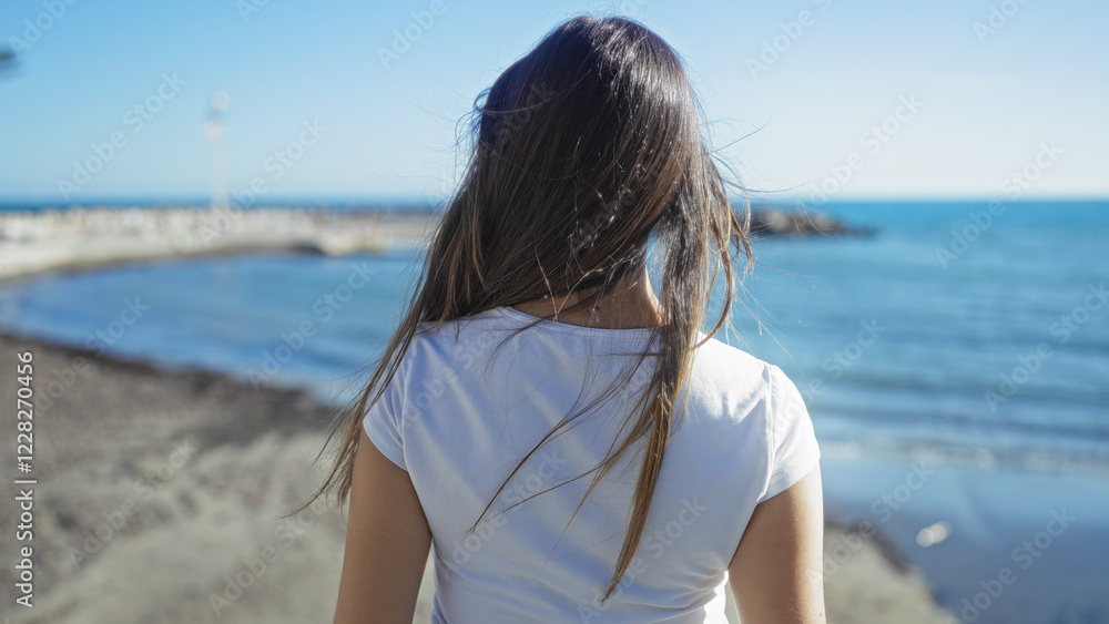 Woman enjoying seaside promenade view showcasing urban landscape with bright ocean under sunny sky, highlighting moment of relaxation and beauty. Woman enjoying seaside promenade view showcasing urban landscape with bright ocean under sunny sky, highlighting moment of relaxation and beauty.