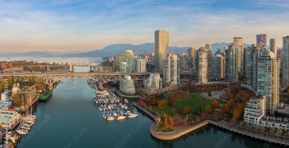 Naklejka premium Vancouver skyline, harbor, and bridge. Boats in marina, park, and modern high-rise buildings. Aerial view of urban waterfront. Granville Bridge, Vancouver, British Columbia, Canada
