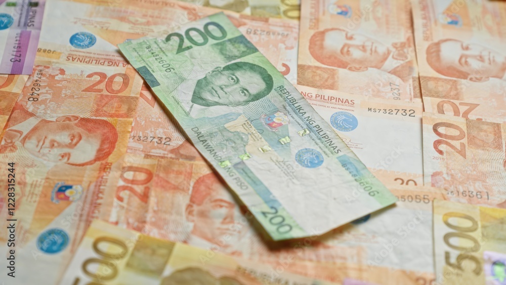Obraz premium Philippine banknotes featuring multiple denominations and prominent historical figures are spread out, highlighting the vibrant and diverse currency designs of the philippines.