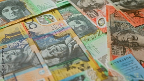 Australian banknotes in various denominations scattered, highlighting vibrant colors, intricate designs, and diverse portraits, capturing australia's unique currency details vividly.