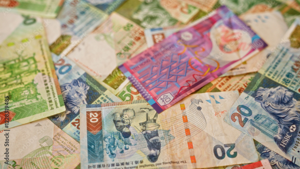 Hong kong dollar banknotes scattered in an overlapping manner, showcasing a colorful array of currency notes from hong kong. Hong kong dollar banknotes scattered in an overlapping manner, showcasing a colorful array of currency notes from hong kong.
