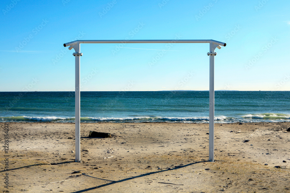 Exercise bar on the beach near the water on a clear blue day Exercise bar on the beach near the water on a clear blue day