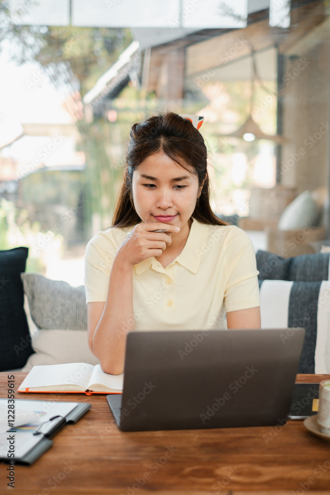 A young woman focused on her laptop in a stylish home office, surrounded by natural light and modern decor. A young woman focused on her laptop in a stylish home office, surrounded by natural light and modern decor.