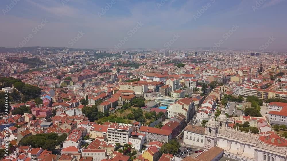 LISBON, PORTUGAL - JANUARY 22, 2025: Aerial view of charming neighborhood featuring red-tiled roofs and vibrant city life LISBON, PORTUGAL - JANUARY 22, 2025: Aerial view of charming neighborhood featuring red-tiled roofs and vibrant city life