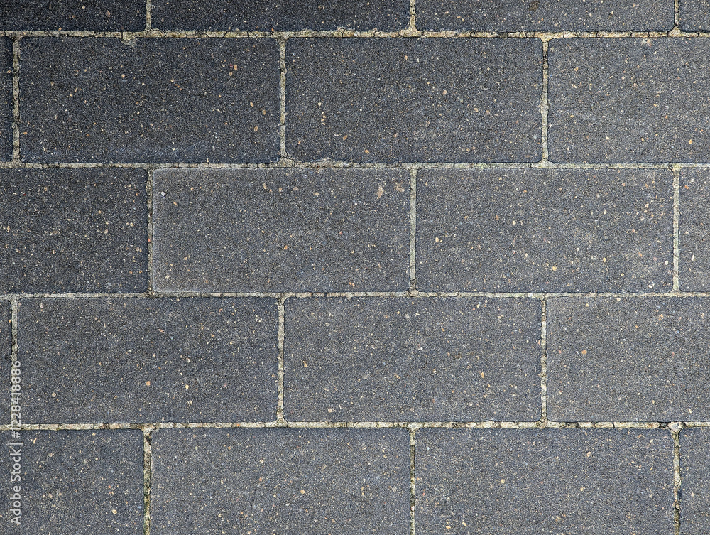 Top view of gray concrete paving stone floor for urban outdoor pavement, walkway, parking lot surface, garage, street. Grayish cement bricks texture background for outdoor paving. Top view of gray concrete paving stone floor for urban outdoor pavement, walkway, parking lot surface, garage, street. Grayish cement bricks texture background for outdoor paving.