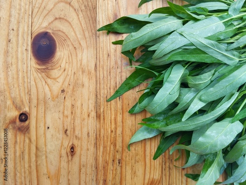 Fresh water spinach or kangkung on wooden table, vegetarian raw food, copy space  photo