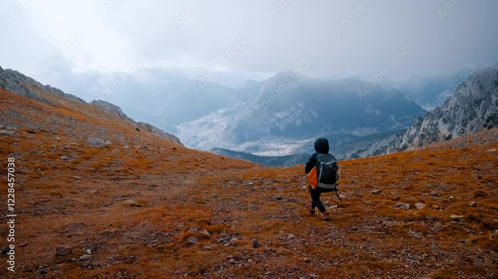 Hiker exploring the rugged landscape of the Pyrenees in Spain Hiker exploring the rugged landscape of the Pyrenees in Spain
