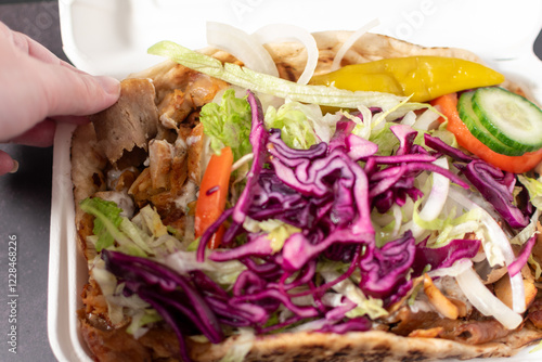 Obraz na płótnie yummy doner kebab with salad and garlic sauce in a takeaway tray