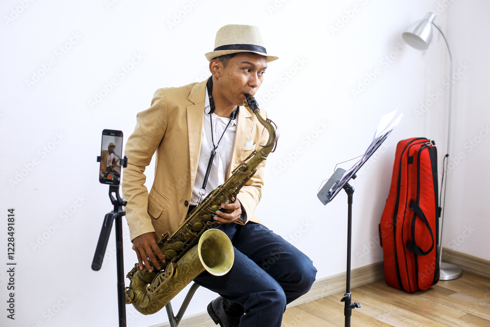 Naklejka premium Side View Of Saxophonist Playing A Music While Recording Vlog Using Smartphone At Music Studio 
