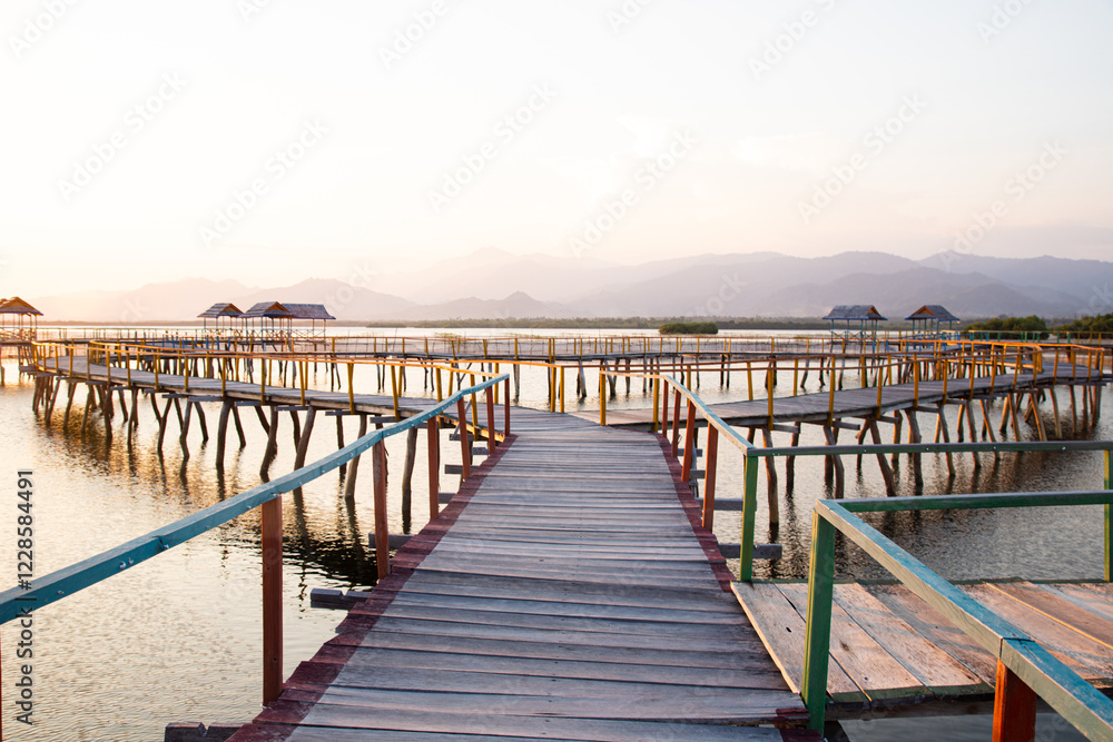 Fototapeta premium beautiful wooden bridge on the beach at sunset