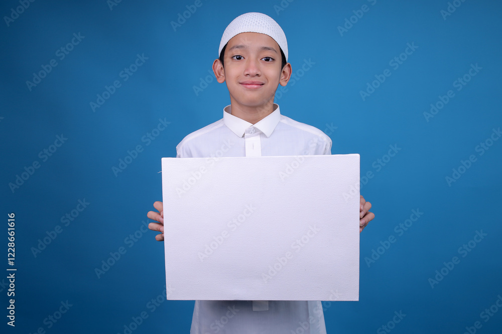 Cheerful Young Muslim Boy Holding Blank Empty Banner, Placard, White Board, Blank Sign Board For Mockup Cheerful Young Muslim Boy Holding Blank Empty Banner, Placard, White Board, Blank Sign Board For Mockup