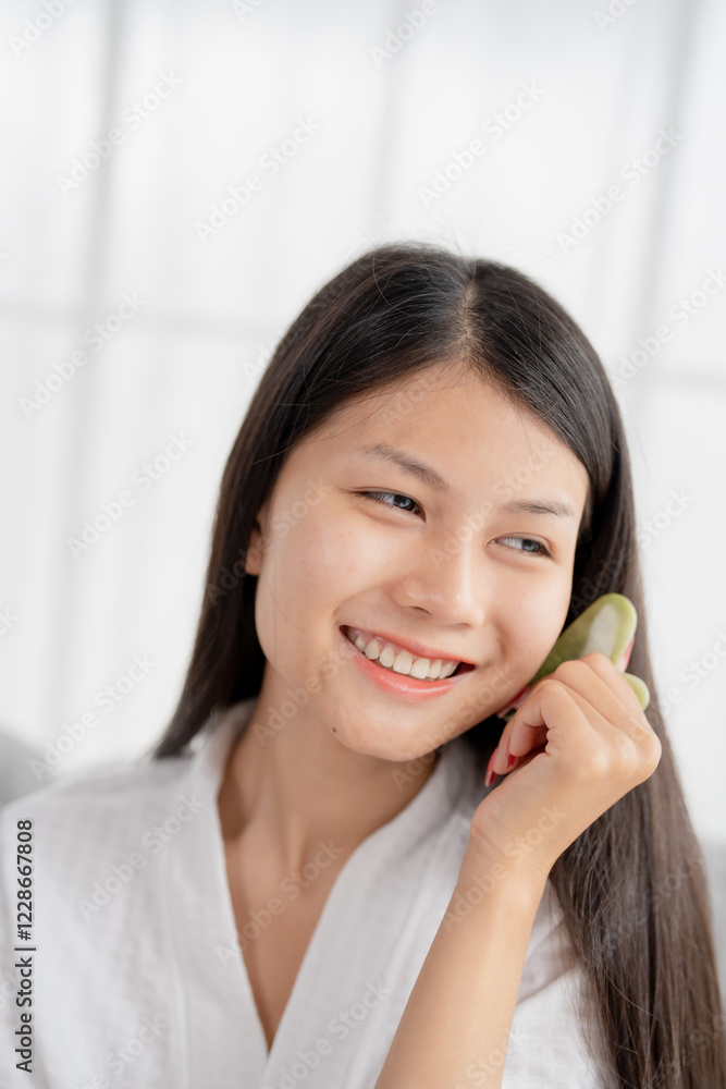 Daily beauty routine Asian woman self care doing gua sha facial massage Traditional medicine Gua Sha quartz stone Cosmetic natural trend. Daily beauty routine Asian woman self care doing gua sha facial massage Traditional medicine Gua Sha quartz stone Cosmetic natural trend.