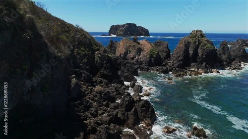 Waves Crashing Against The Rocky Coast And Cliffs At Playa la Morita In Tenacatita, Jalisco, Mexico. - aerial shot photo