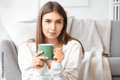Young woman with cup of hot...