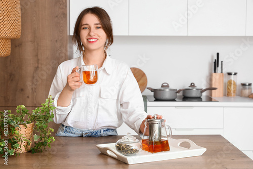 Young woman with glass cup ...