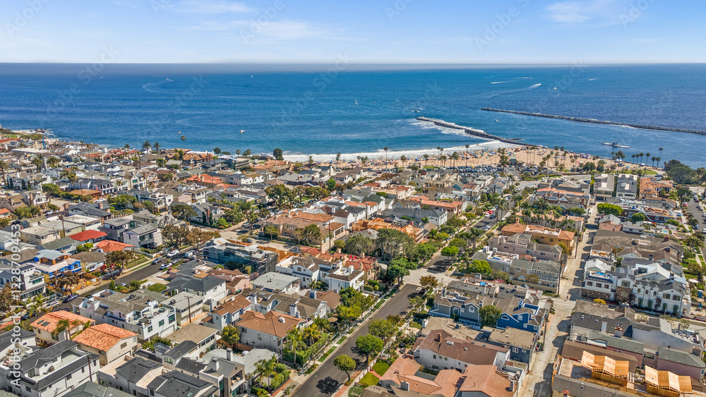 Naklejka premium Luxury home, Newport Beach, ocean view, modern house, real estate, sunset photography, coastal property, high-end architecture, elegant design, premium listing, exterior lighting, waterfront home