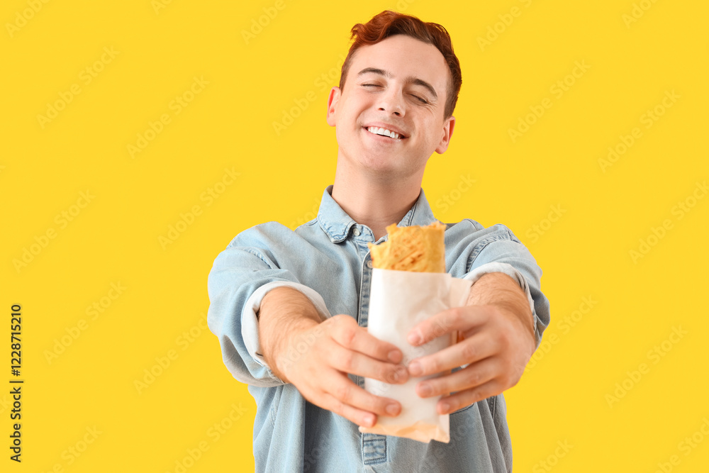 Young man with tasty sandwich wrap on yellow background Young man with tasty sandwich wrap on yellow background