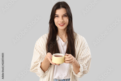 Pretty young woman with cup...