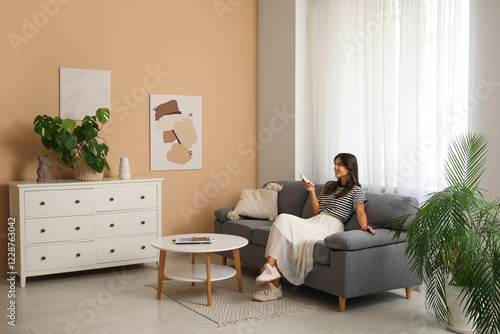 Young woman relaxing on sof...