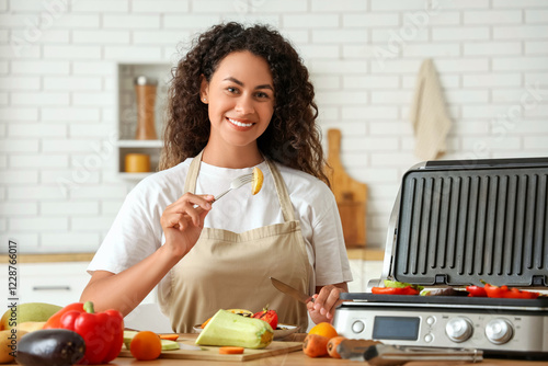 Smiling woman grilling fres...