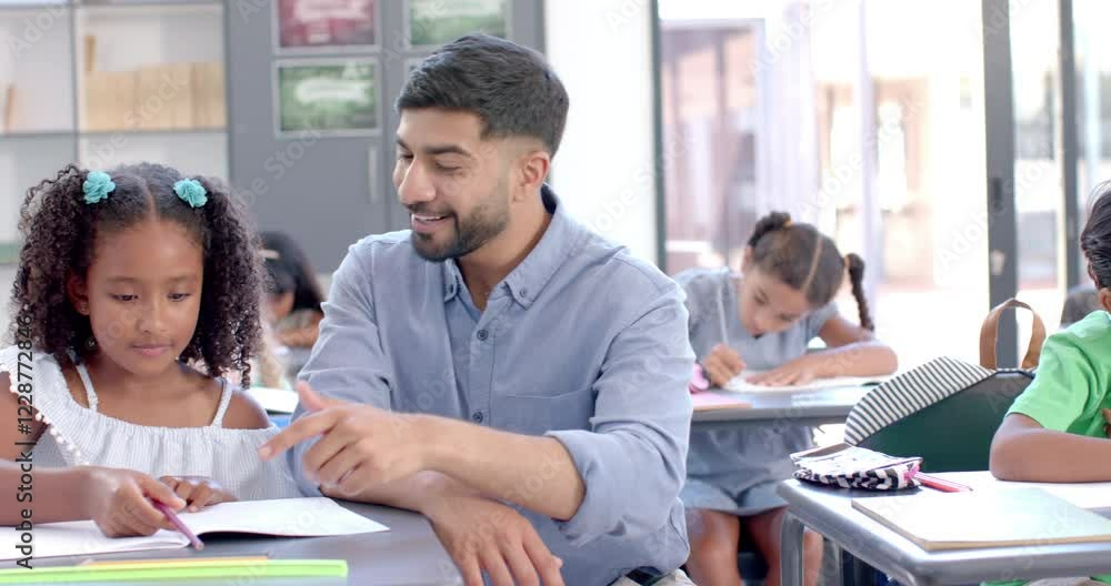 Biracial girl enjoys a high-five with her teacher at school in the classroom Biracial girl enjoys a high-five with her teacher at school in the classroom