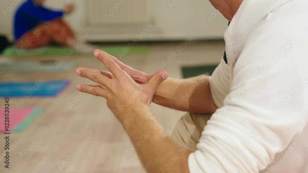 Experienced yoga instructor forming sacred hand gesture during meditation class, highlighting spiritual connection and mindful body language with precise, intentional movement Experienced yoga instructor forming sacred hand gesture during meditation class, highlighting spiritual connection and mindful body language with precise, intentional movement