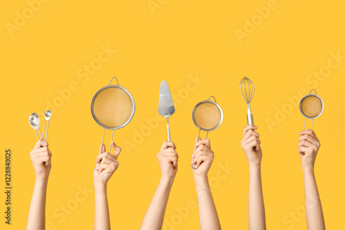 Hands holding kitchen utens...