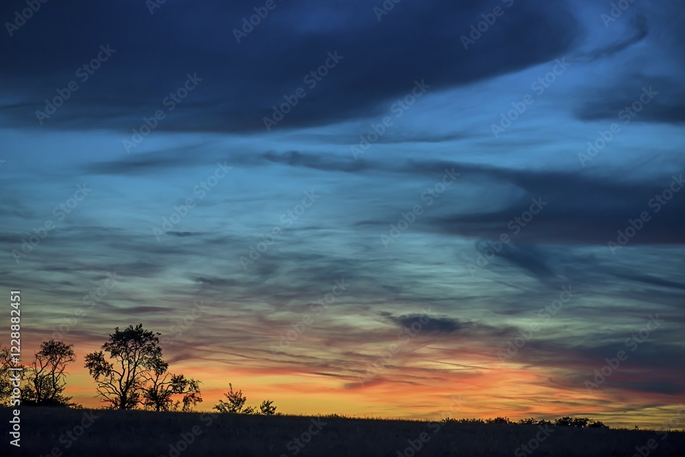 Fototapeta premium Tree silouettes with dark clouds at sunset, Bavaria, Germany, Europe