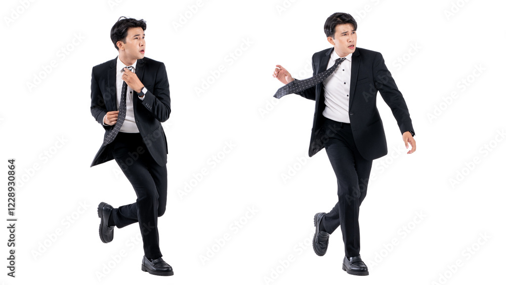A man in a black suit and tie stands in front of a white background A man in a black suit and tie stands in front of a white background