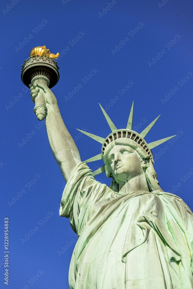 Fototapeta premium Statue of Liberty in front of blue sky, Liberty Island, Statue of Liberty National Monument, New York City, New York, USA, North America