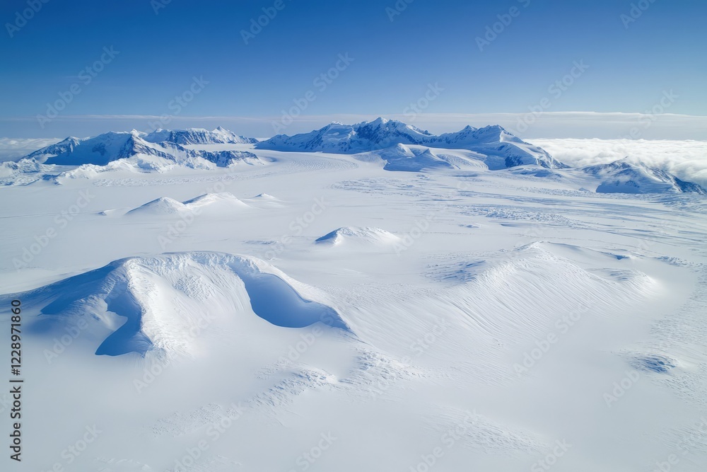 Aerial View of Antarctic Landscape: Pristine Snowdrifts and Majestic Mountains Under a Clear Blue Sky. Aerial View of Antarctic Landscape: Pristine Snowdrifts and Majestic Mountains Under a Clear Blue Sky.
