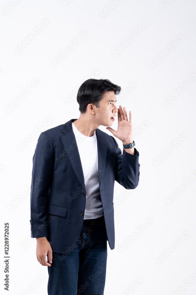 A man in a suit is smiling while looking at his cell phone A man in a suit is smiling while looking at his cell phone