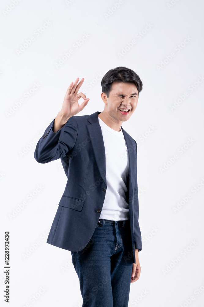 A man in a blue suit and white shirt poses for a photo