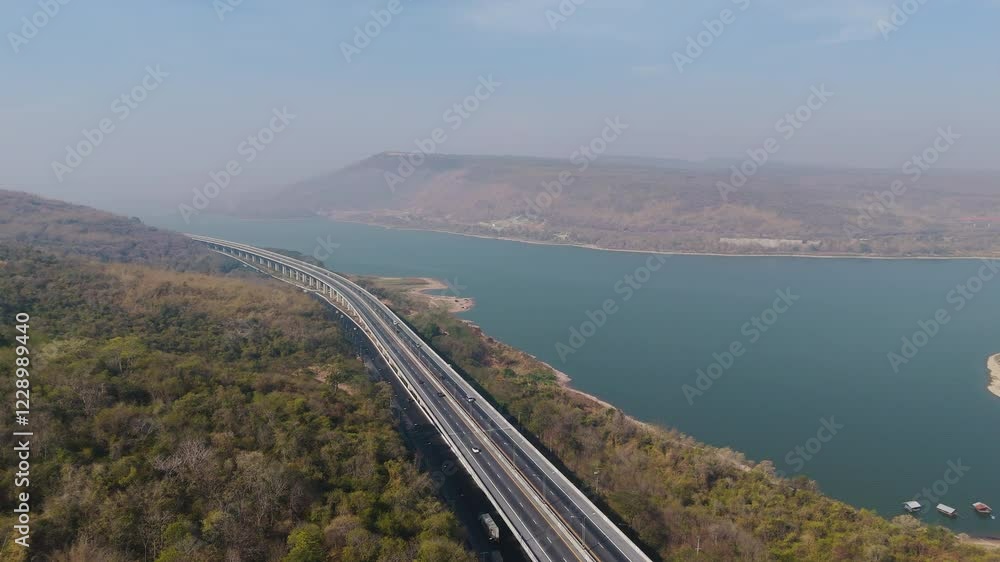 The M6 motorway Expressway Nakhon Ratchasima Province - Bang Pa-in. Lam Ta Khong River and Mountain. Drone shot of scenic landscape rural place traffic. Nakhon Ratchasima Thailand. Motorway Korat The M6 motorway Expressway Nakhon Ratchasima Province - Bang Pa-in. Lam Ta Khong River and Mountain. Drone shot of scenic landscape rural place traffic. Nakhon Ratchasima Thailand. Motorway Korat