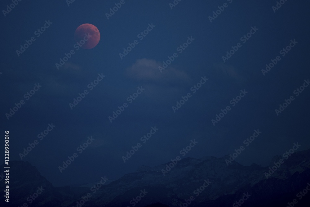Bloodmoon, total lunar eclipse over mountain range, Immensee, Switzerland, Europe Bloodmoon, total lunar eclipse over mountain range, Immensee, Switzerland, Europe