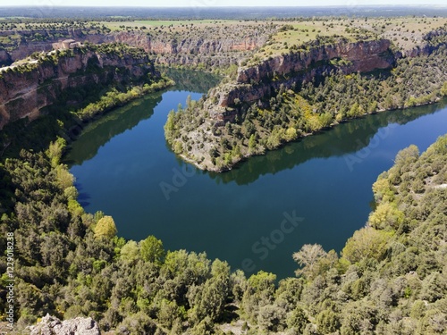 A deep gorge with a calm river surrounded by lush vegetation and trees under a clear sky, aerial view, gorge, Natural Park of the Gorges of the Duratón River, Duraton, Parque Natural de las Hoces del Río Duratón, Segovia, Valladolid, Castilla y León, Spain, KI generated, AI generated, Europe photo