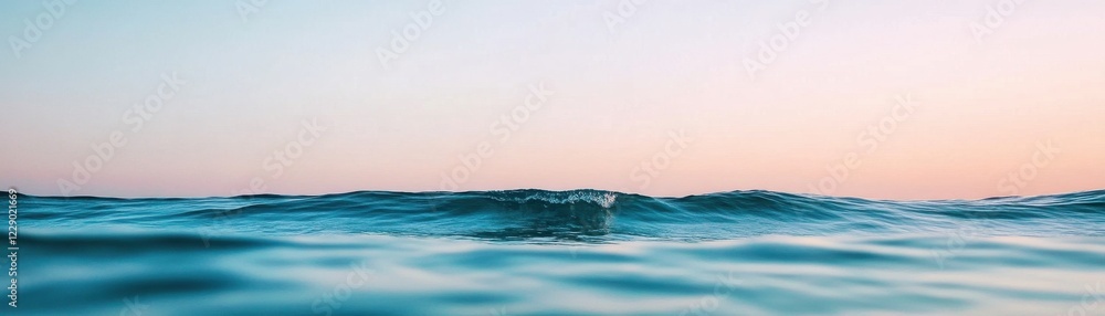 Naklejka premium Calm Ocean Waves Under a Serene Sky at Sunset, Embracing Nature's Tranquility