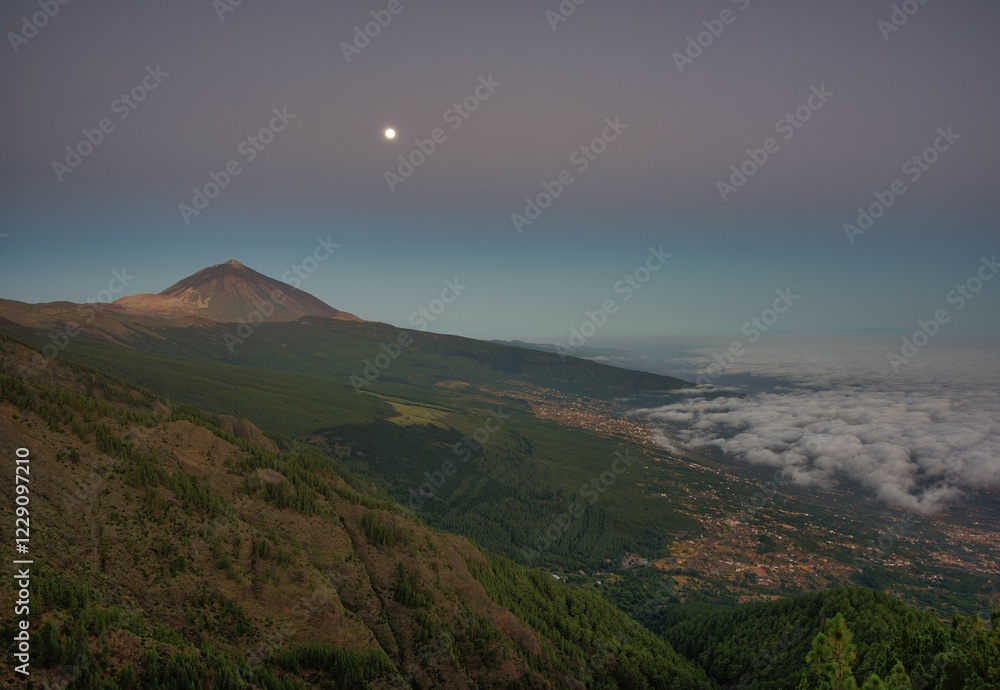 Fototapeta premium Night view of trade wind clouds over Orotava valley with Pico del Teide in front of sunrise, behind La Palma, Teide National Park, Tenerife, Canary Islands, Spain, Europe