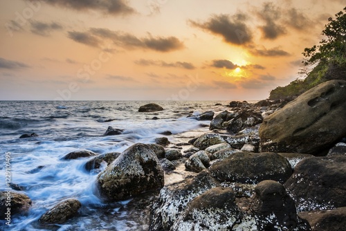 Sunset at rocky coast near Long Beach in Sok San village on Koh Rong island, Krong Preah Sihanouk, Sihanoukville, Cambodia, Asia photo