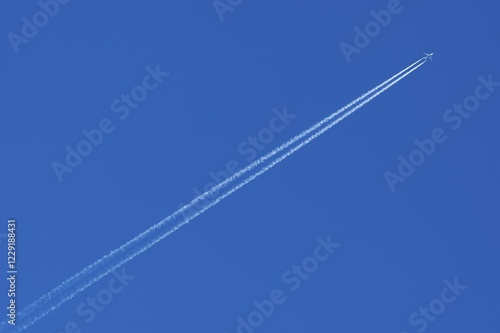 Obraz na płótnie Plane with contrails in the blue sky, Germany, Europe w salonie