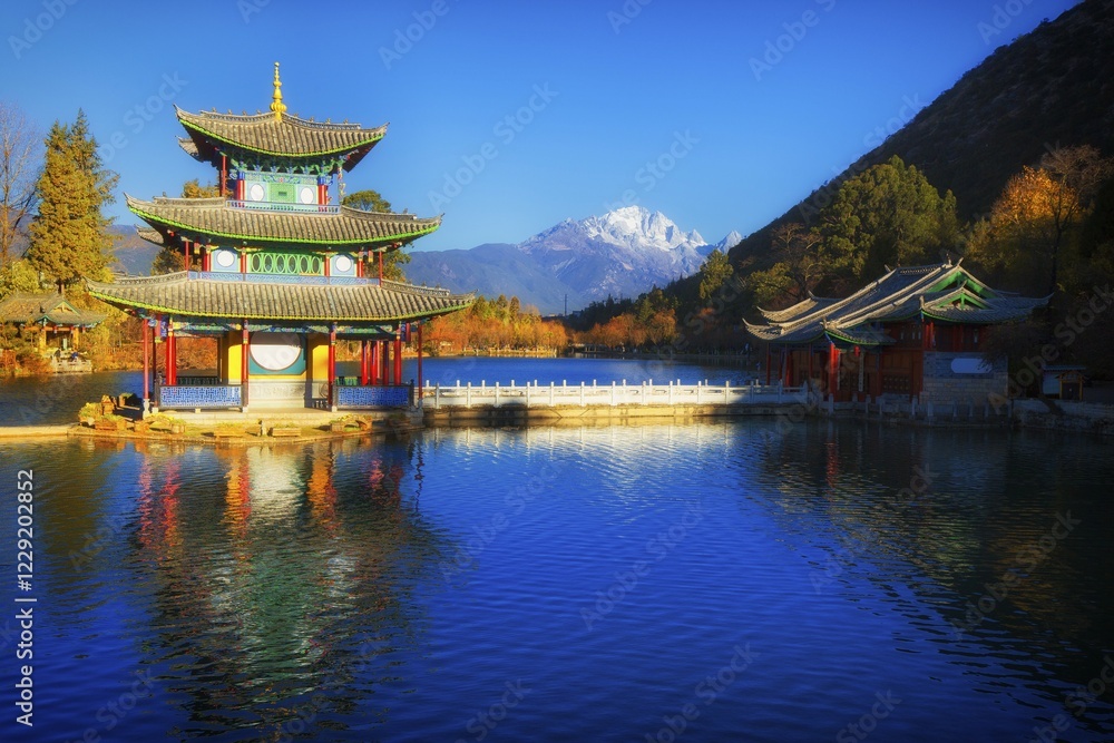 Obraz premium Chinese pagoda, Deyue Pavilion, reflected in Black Dragon Lake, Black Dragon Pool, in the background Jade Dragon Mountain, Unesco World Heritage Site, Lijiang, Yunnan Province, China, Asia
