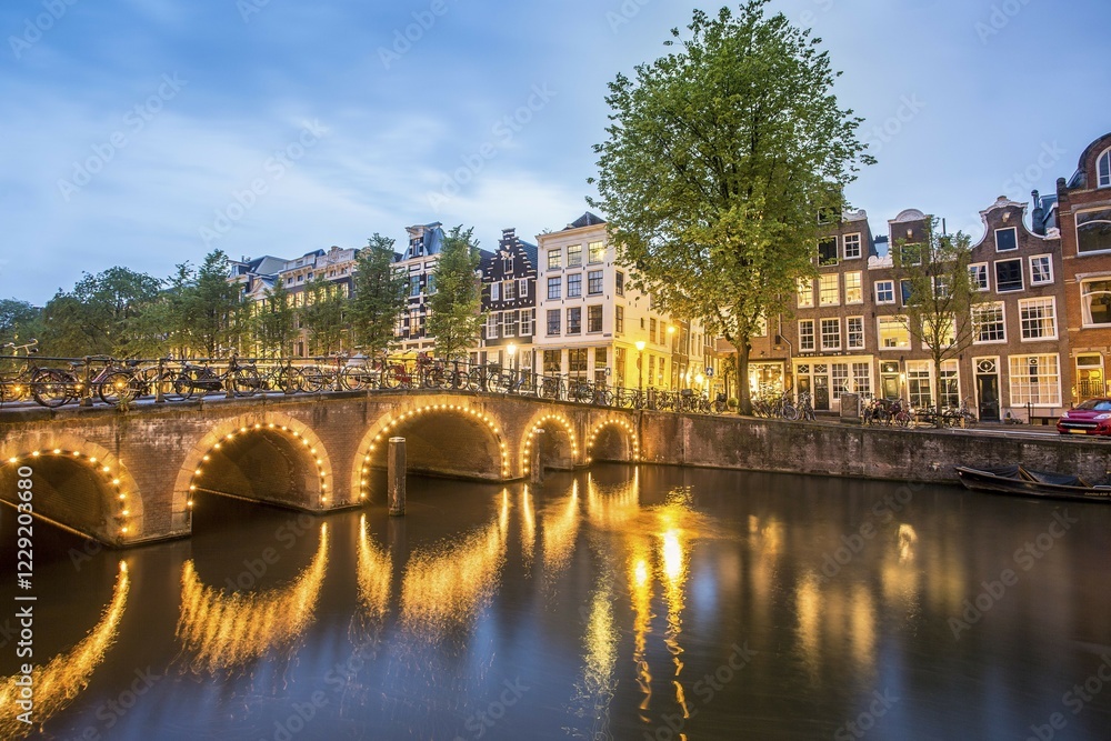 Naklejka premium Historical houses by the canal at dusk, Amsterdam, Netherlands
