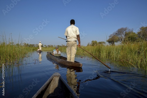 Wallpaper Mural Tourists in a mokoro or dugout boat on safari in swamp area, Gomoti Plains Camp, Gomoti Concession Area, Okavango Delta, Botswana, Africa Torontodigital.ca