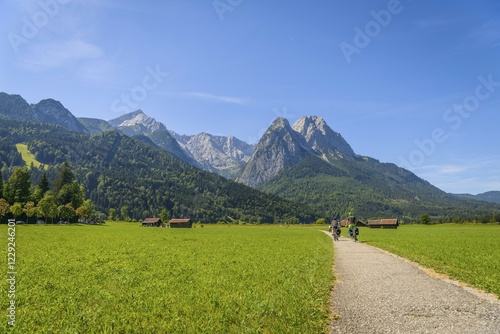 Bild auf Leinwand Cyclists on the Via Claudia Augusta long-distance cycle path, in the back Zugspi