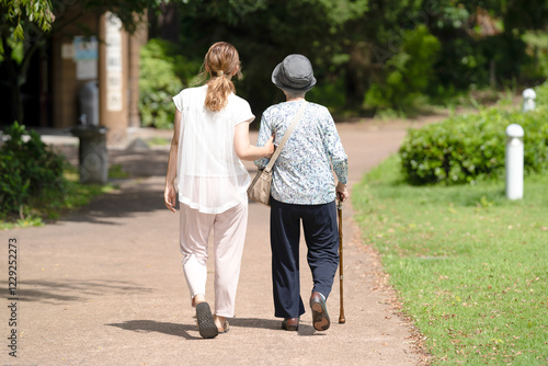 A park with good atmosphere with canal in Toyama Prefecture. Old woman in her 90s and Japanese woman in her thirties are walking around the park.