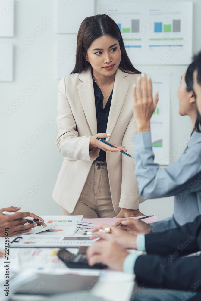 Business Meeting: A female leader, in a professional setting, engages with her team, fostering discussion, collaboration, and brainstorming during a pivotal meeting. Business Meeting: A female leader, in a professional setting, engages with her team, fostering discussion, collaboration, and brainstorming during a pivotal meeting.